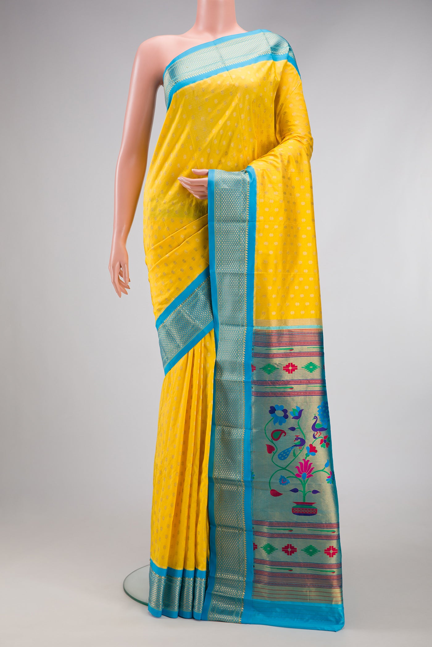 Lemon Yellow Paithani Silk Saree with Zari Butta on the body and Zari Border.  displayed on a mannequin