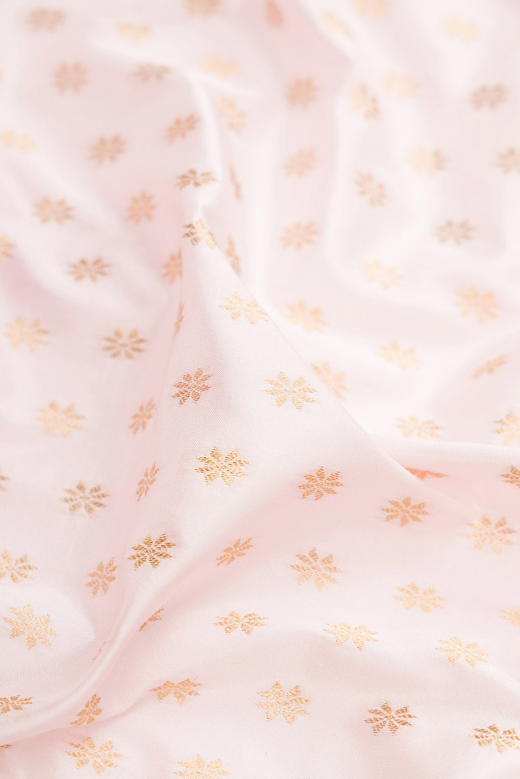 Close up of Off White Paithani Silk Saree with Zari Butta on the body and Zari Border.  displaying folds