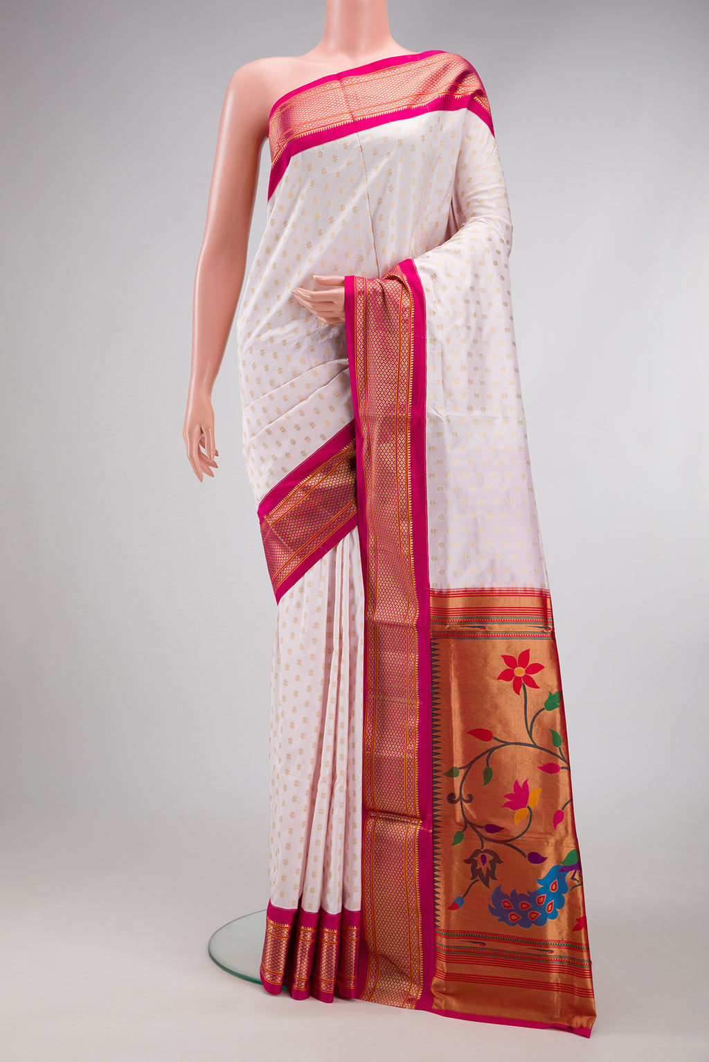 Off White Paithani Silk Saree with Zari Butta on the body and Zari Border.  displayed on a mannequin