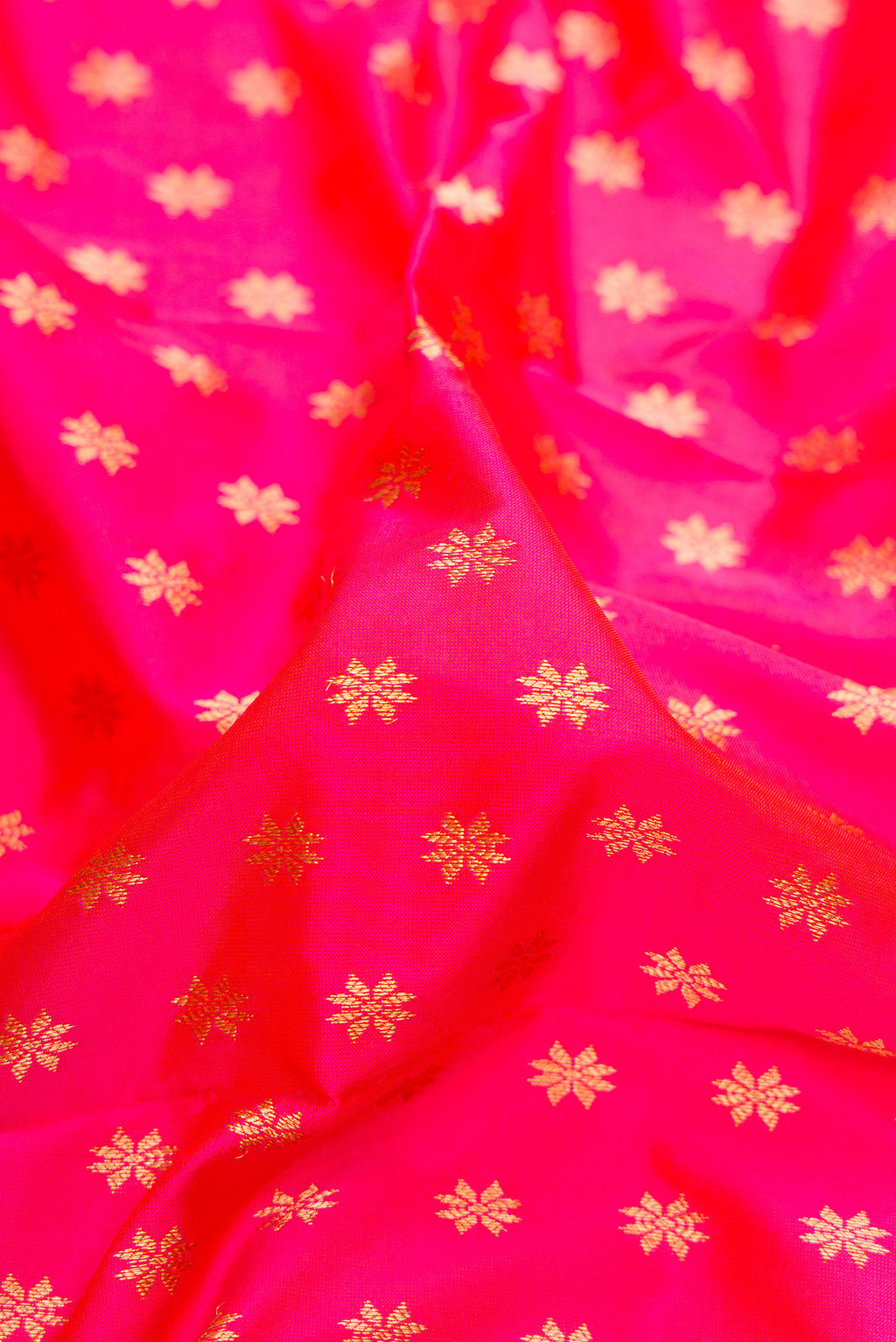 Close up of Pink Paithani Silk Saree with Zari Butta on the body and Zari Border.  displaying folds