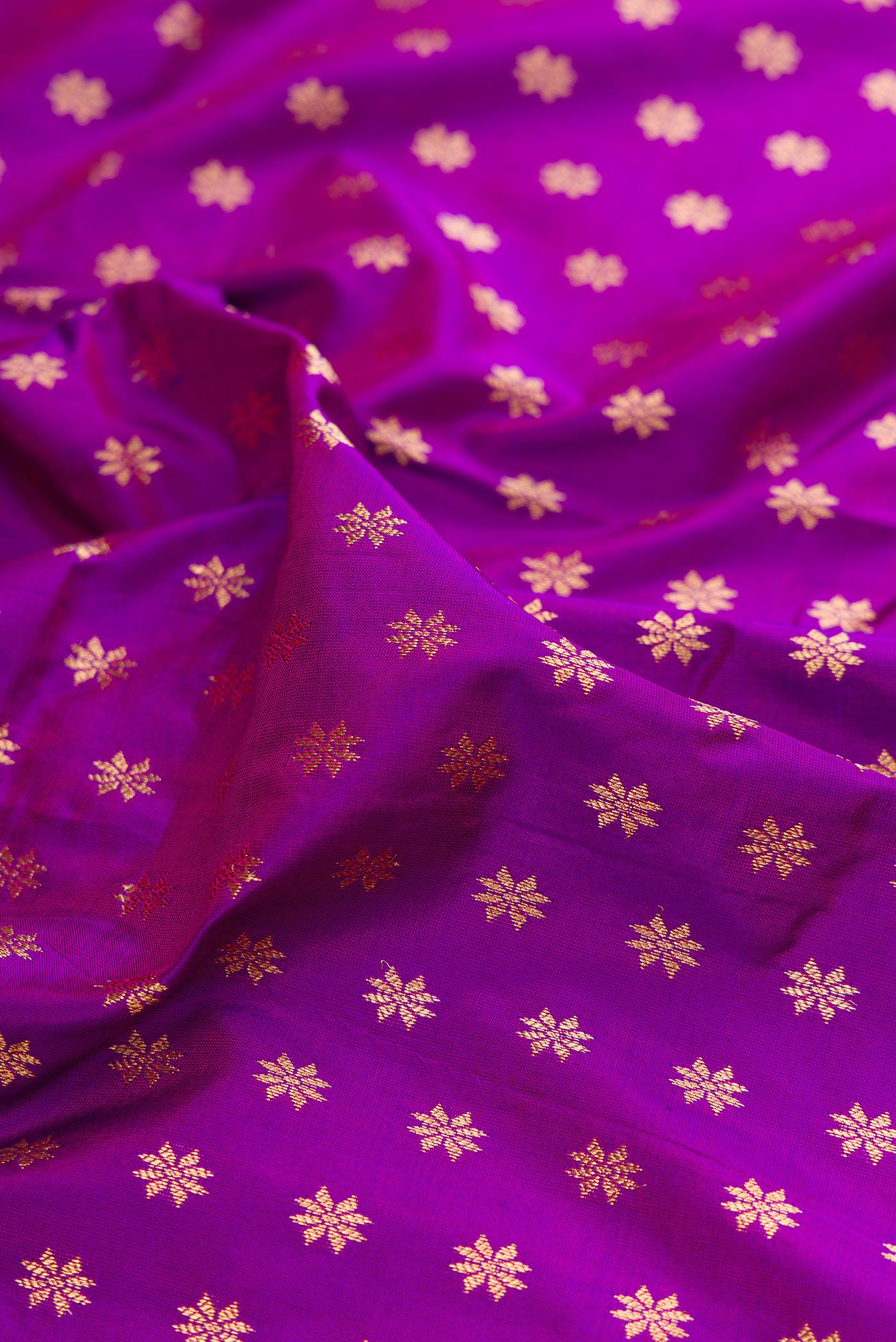 Close up of Purple Paithani Silk Saree with Zari Butta on the body and Zari Border.  displaying folds