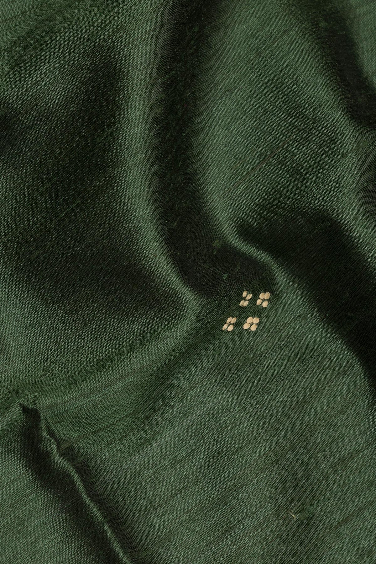 Close up of Olive Green Tussar Saree with Embroidery on the body and Zari Border.  displaying folds