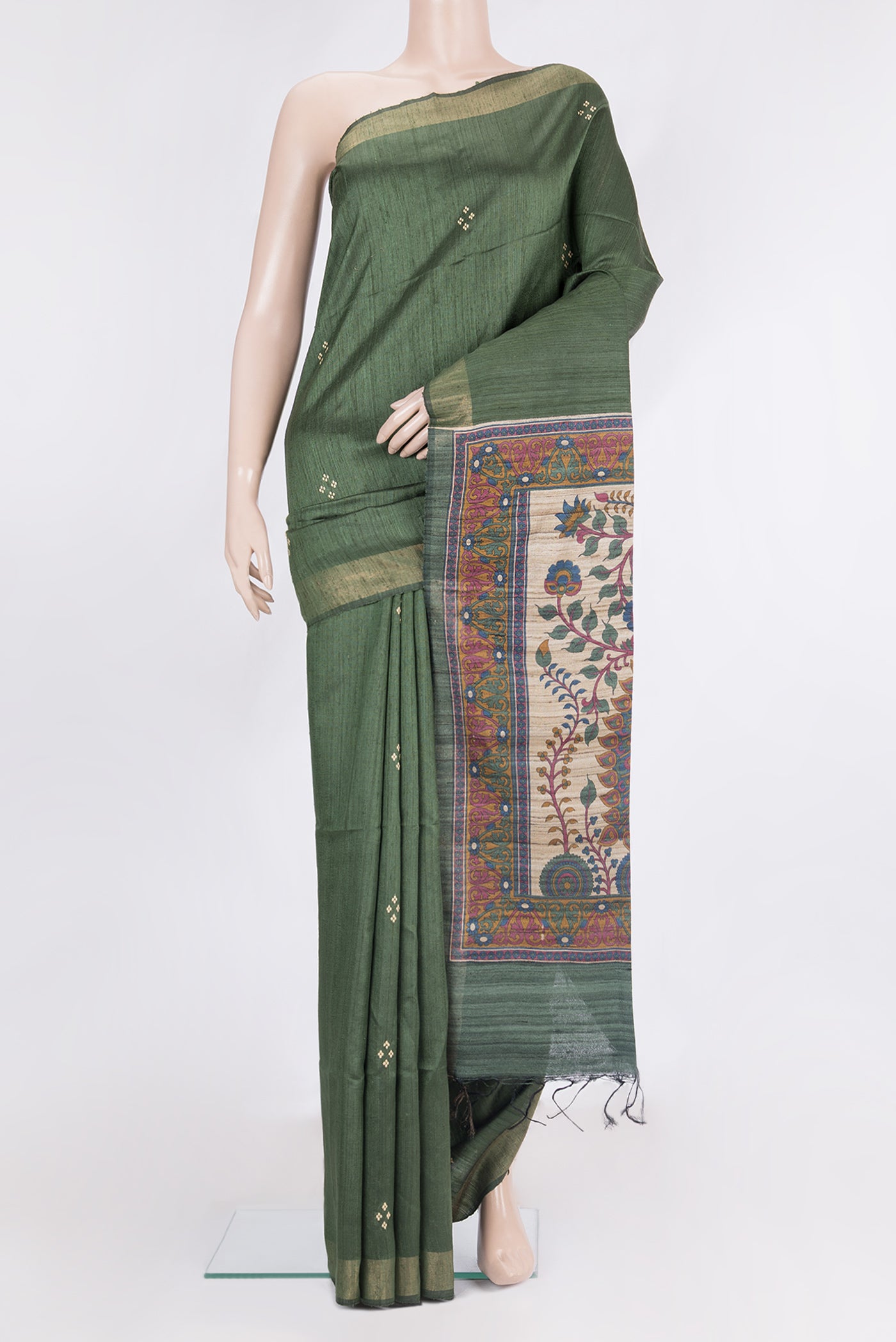 Olive Green Tussar Saree with Embroidery on the body and Zari Border.  displayed on a mannequin