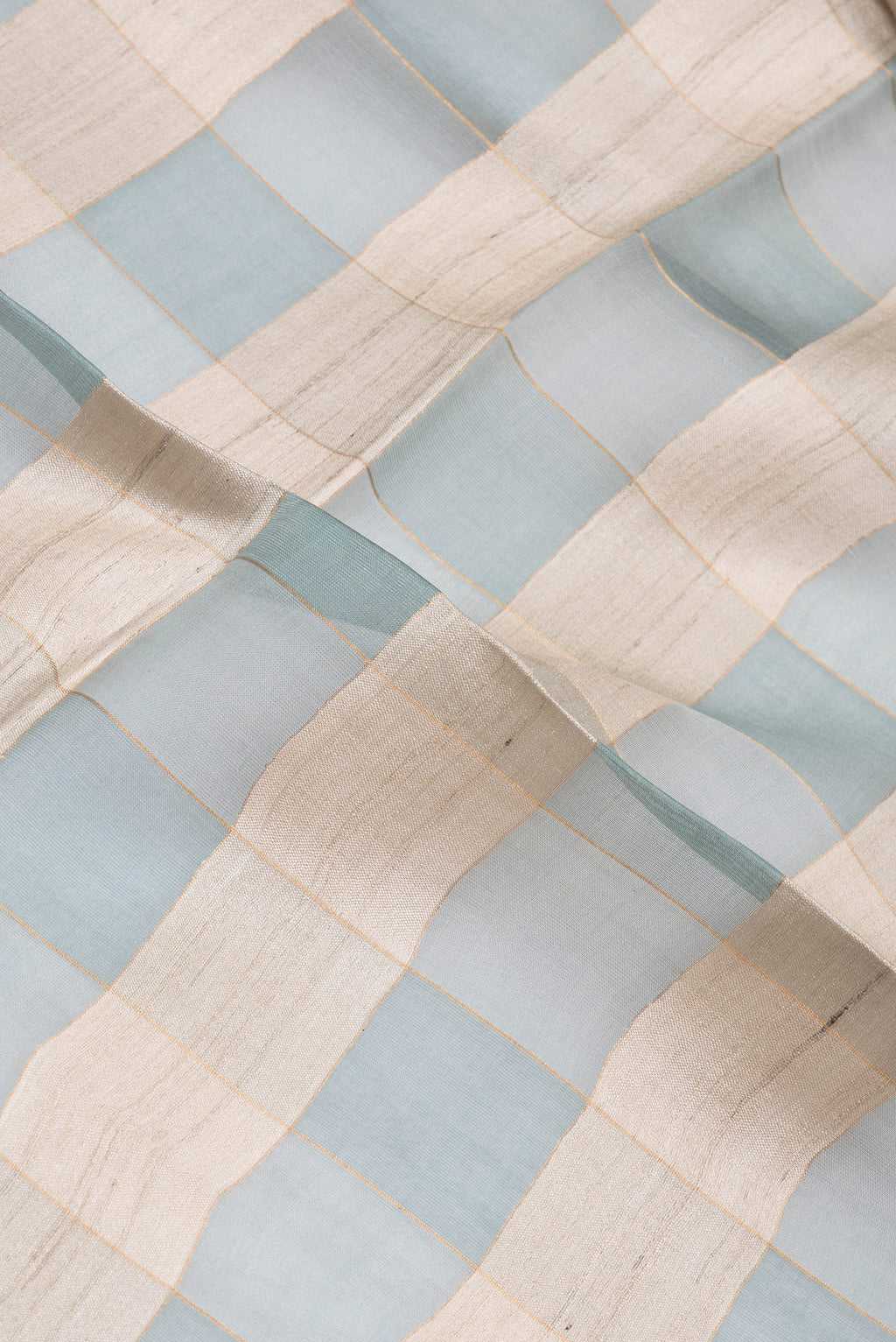 Close up of Multi Color Tussar Silk Saree with Checked design on the body and Zari Border.  displaying folds