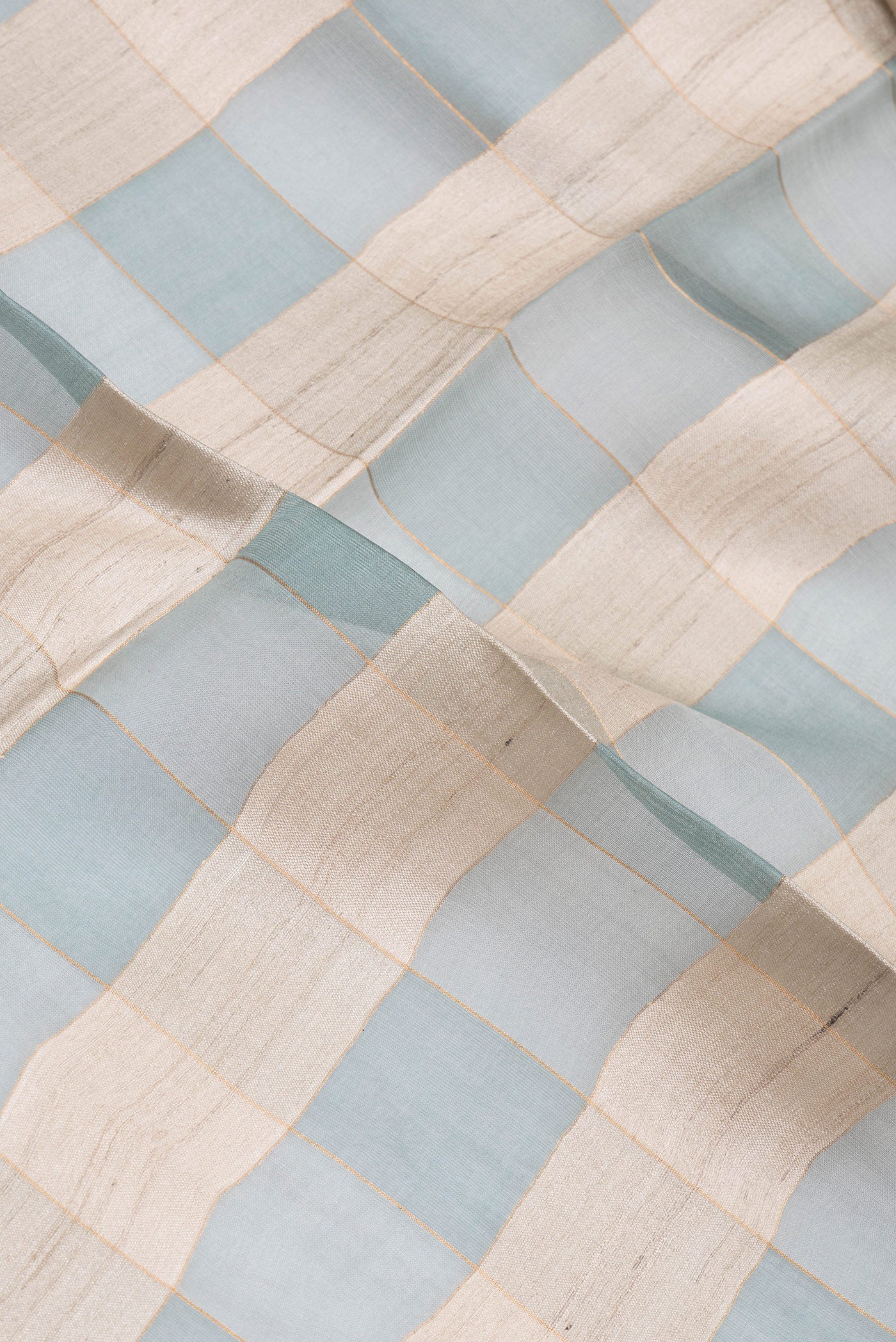 Close up of Multi Color Tussar Silk Saree with Checked design on the body and Zari Border.  displaying folds