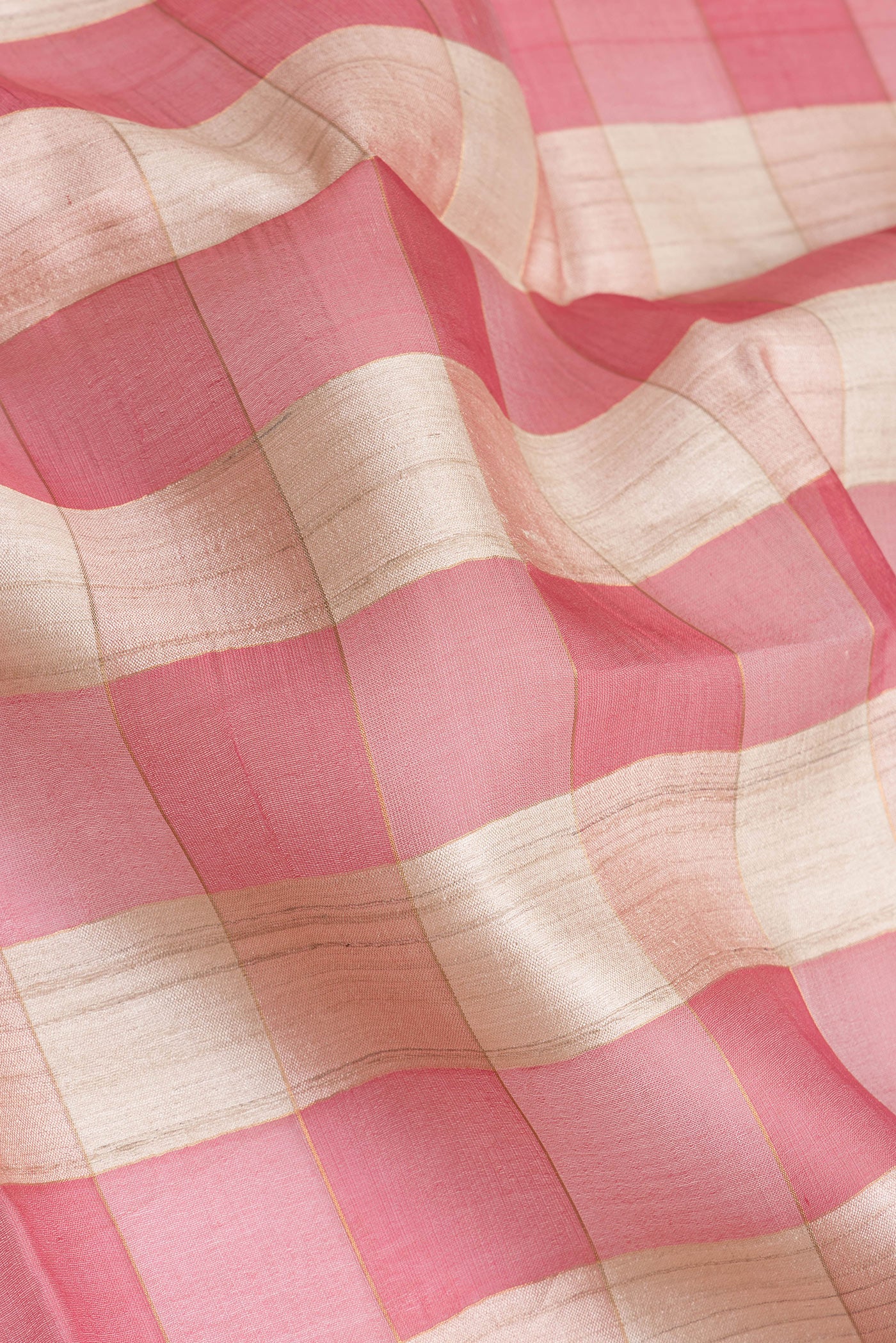 Close up of Multi Color Tussar Silk Saree with Checked design on the body and Zari Border.  displaying folds
