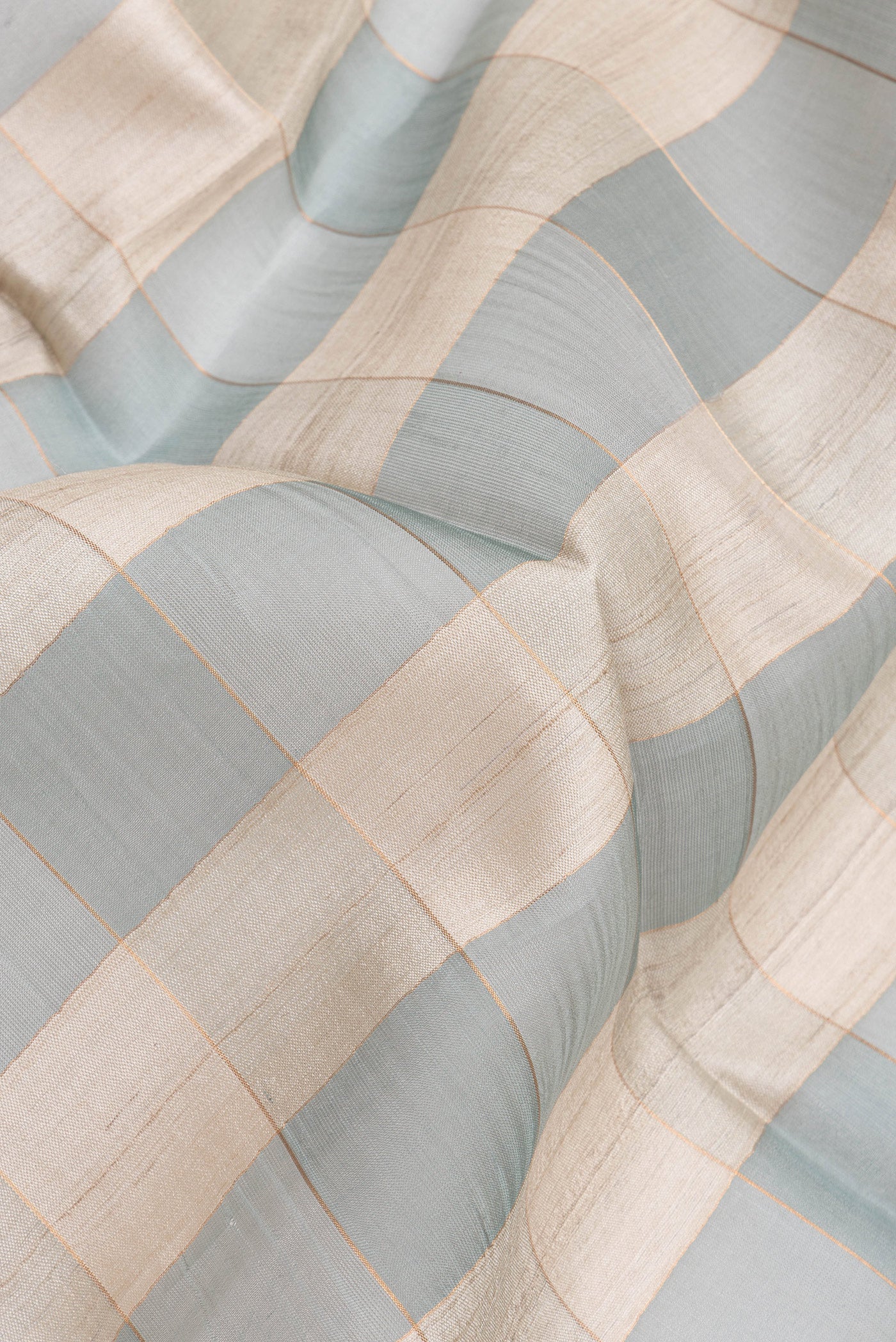 Close up of Multi Color Tussar Silk Saree with Checked design on the body and Zari Border.  displaying folds