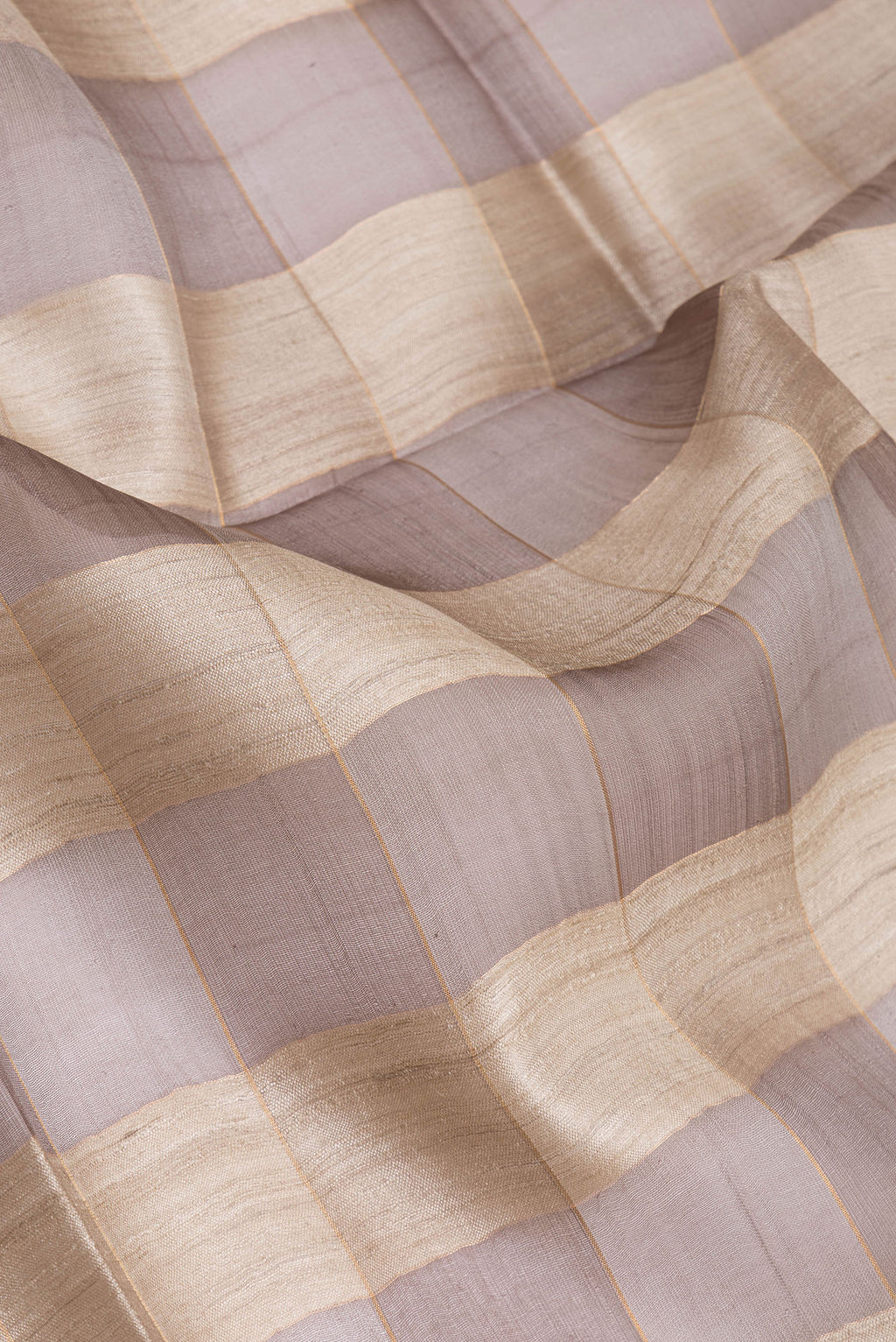 Close up of Multi Color Tussar Silk Saree with Checked design on the body and Zari Border.  displaying folds