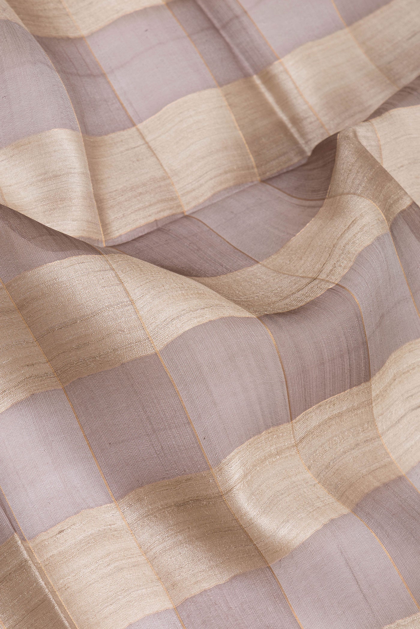 Close up of Multi Color Tussar Silk Saree with Checked design on the body and Zari Border.  displaying folds