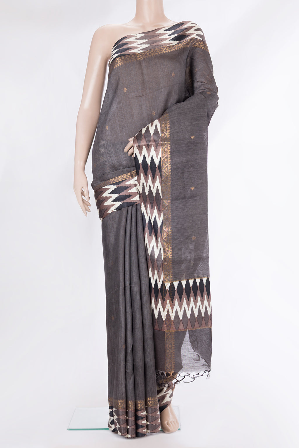Grey Tussar Saree with Zari Butta on the body and Ikat Border.  displayed on a mannequin