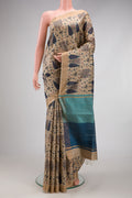 Beige Tussar Silk Saree with Printed design on the body and Zari Border.  displayed on a mannequin
