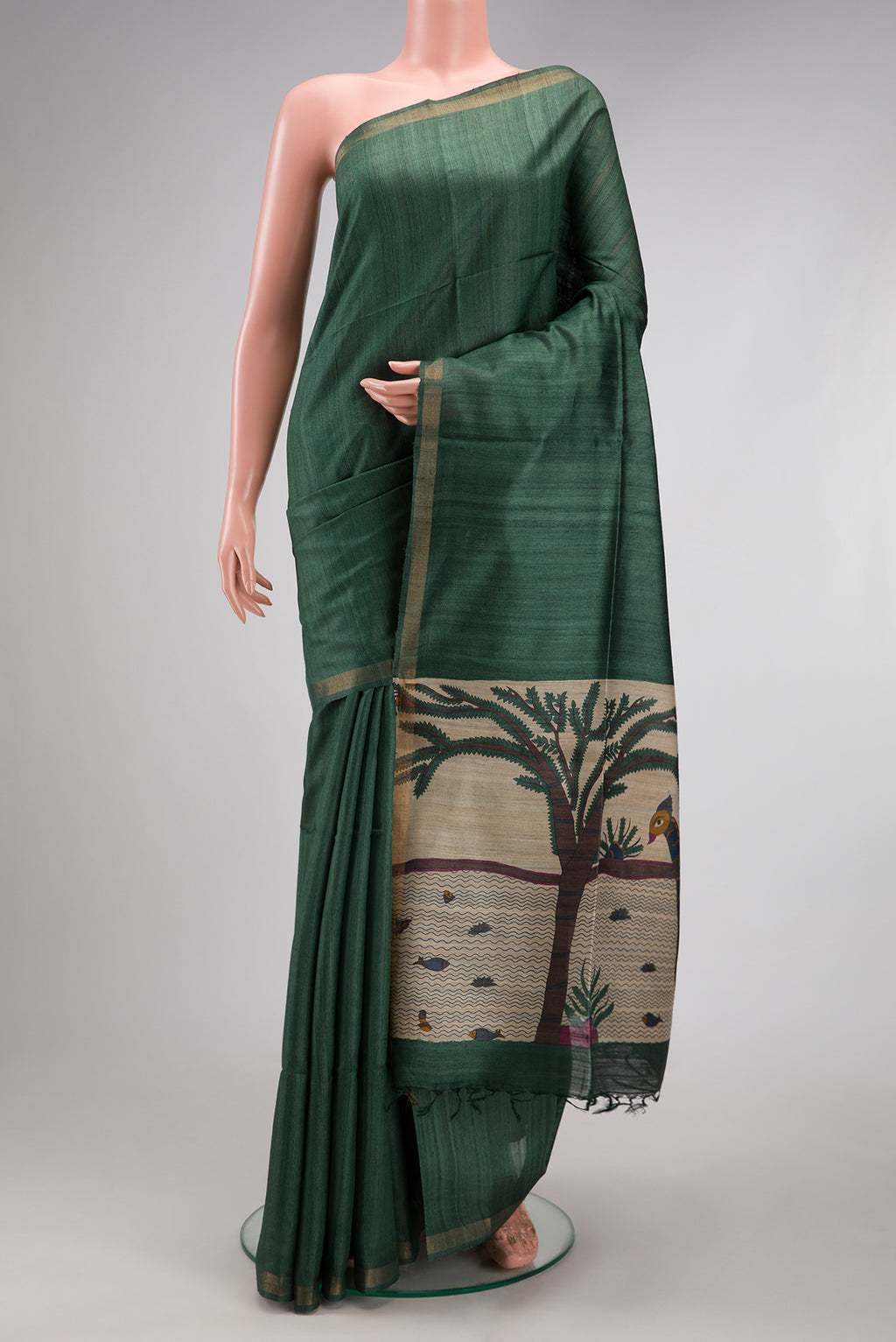 Bottle Green Tussar Silk Saree with Plain Body and Zari Border.  displayed on a mannequin