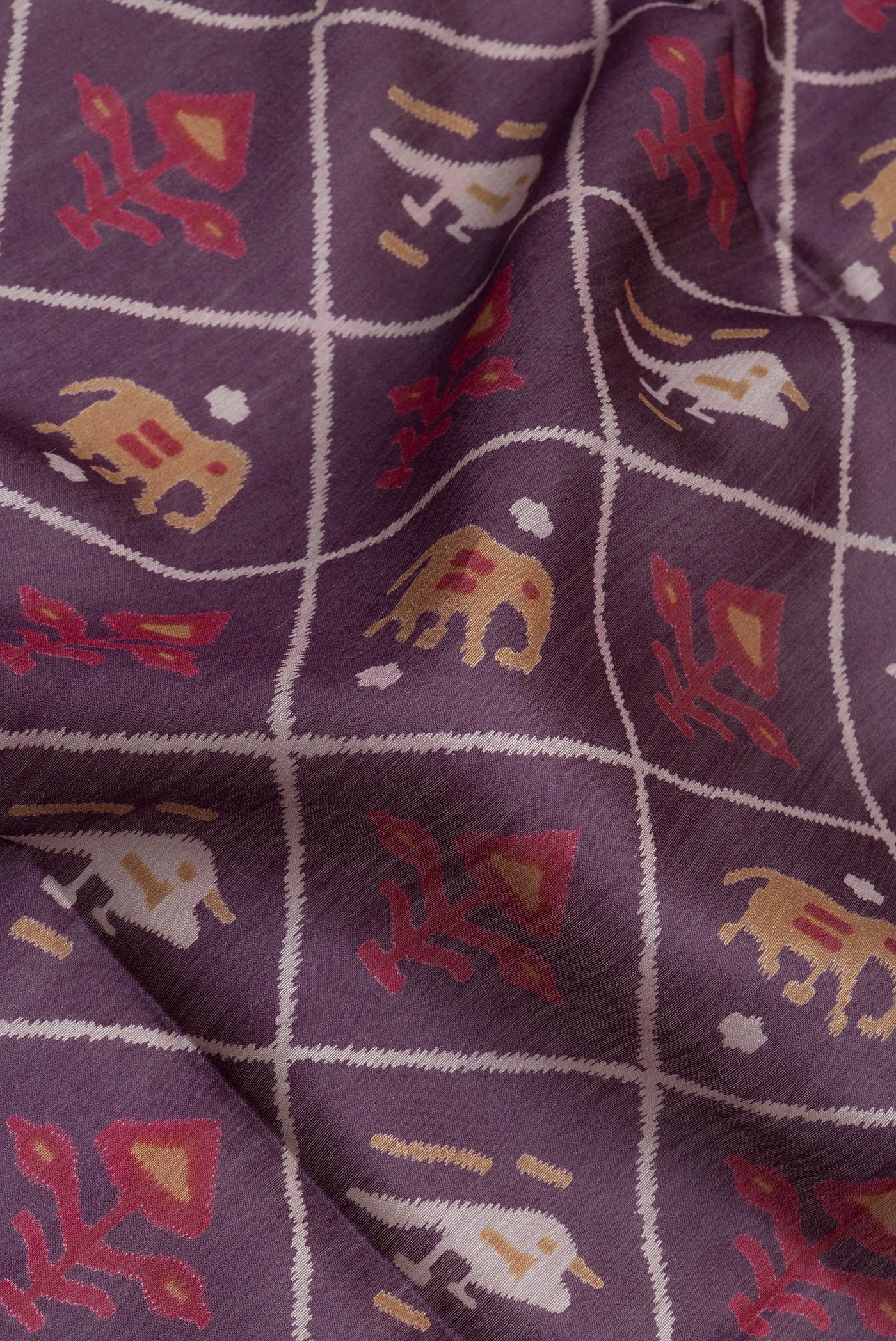 Close up of Purple Tussar Silk Saree with Printed design on the body and Plain Border.  displaying folds