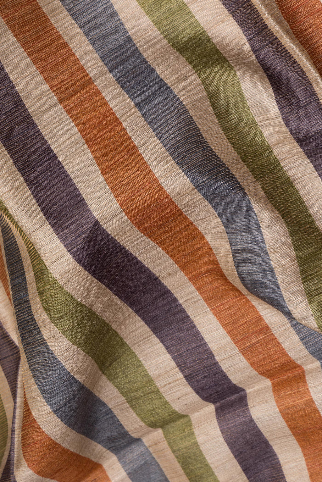 Close up of Pure Silk Beige Tussar Saree with Stripes on the body and Ikat Border.  displaying folds