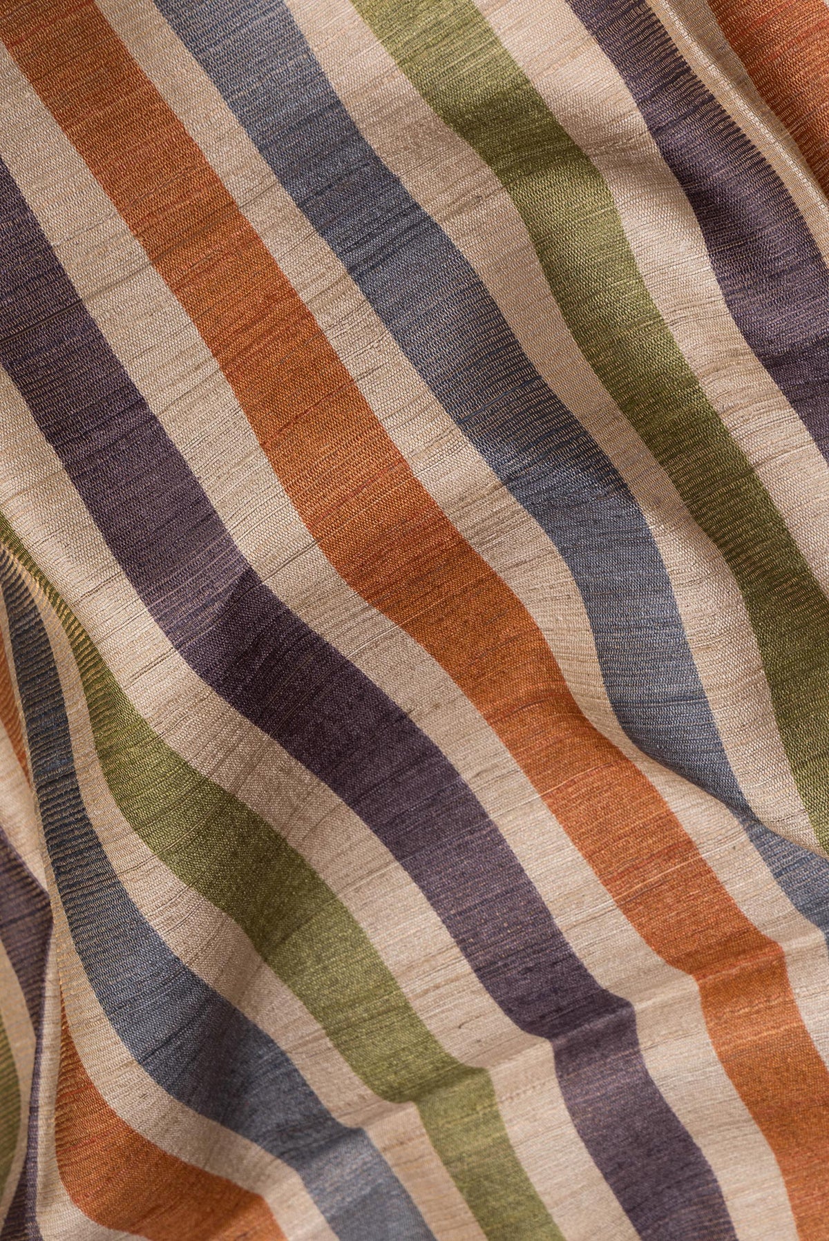 Close up of Pure Silk Beige Tussar Saree with Stripes on the body and Ikat Border.  displaying folds