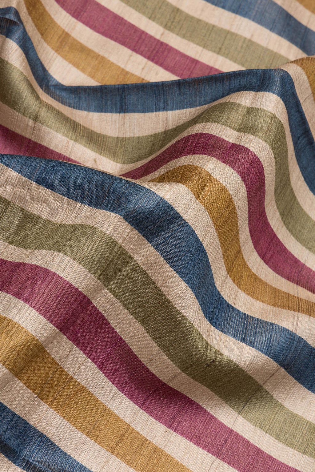 Close up of Multi Color Tussar Silk Saree with Stripes on the body and Ikat Border.  displaying folds