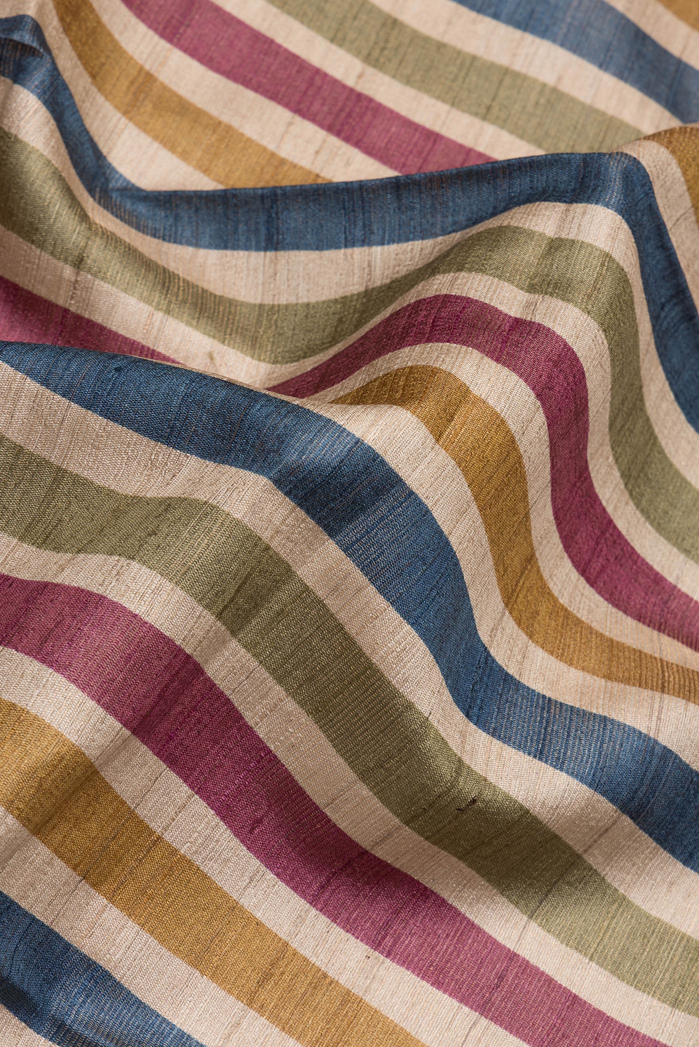 Close up of Multi Color Tussar Silk Saree with Stripes on the body and Ikat Border.  displaying folds