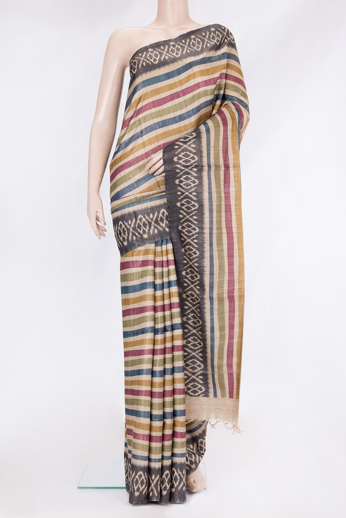 Multi Color Tussar Silk Saree with Stripes on the body and Ikat Border.  displayed on a mannequin
