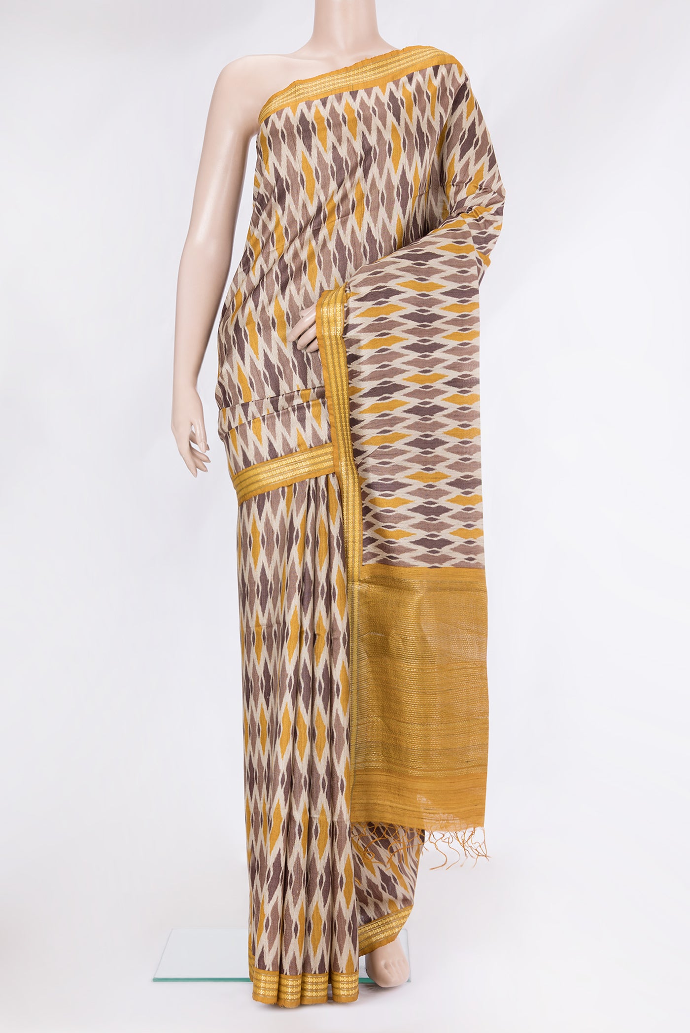 Beige Tussar Silk Saree with Ikat Print on the body and Thread Border.  displayed on a mannequin