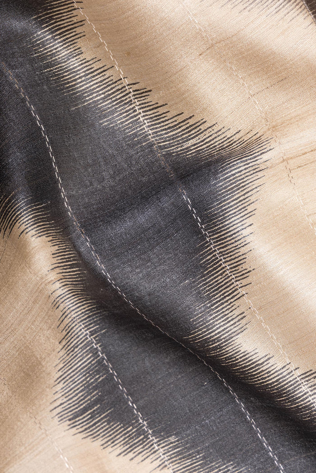 Close up of Beige Tussar Saree with Stripes on the body and Zari Border.  displaying folds