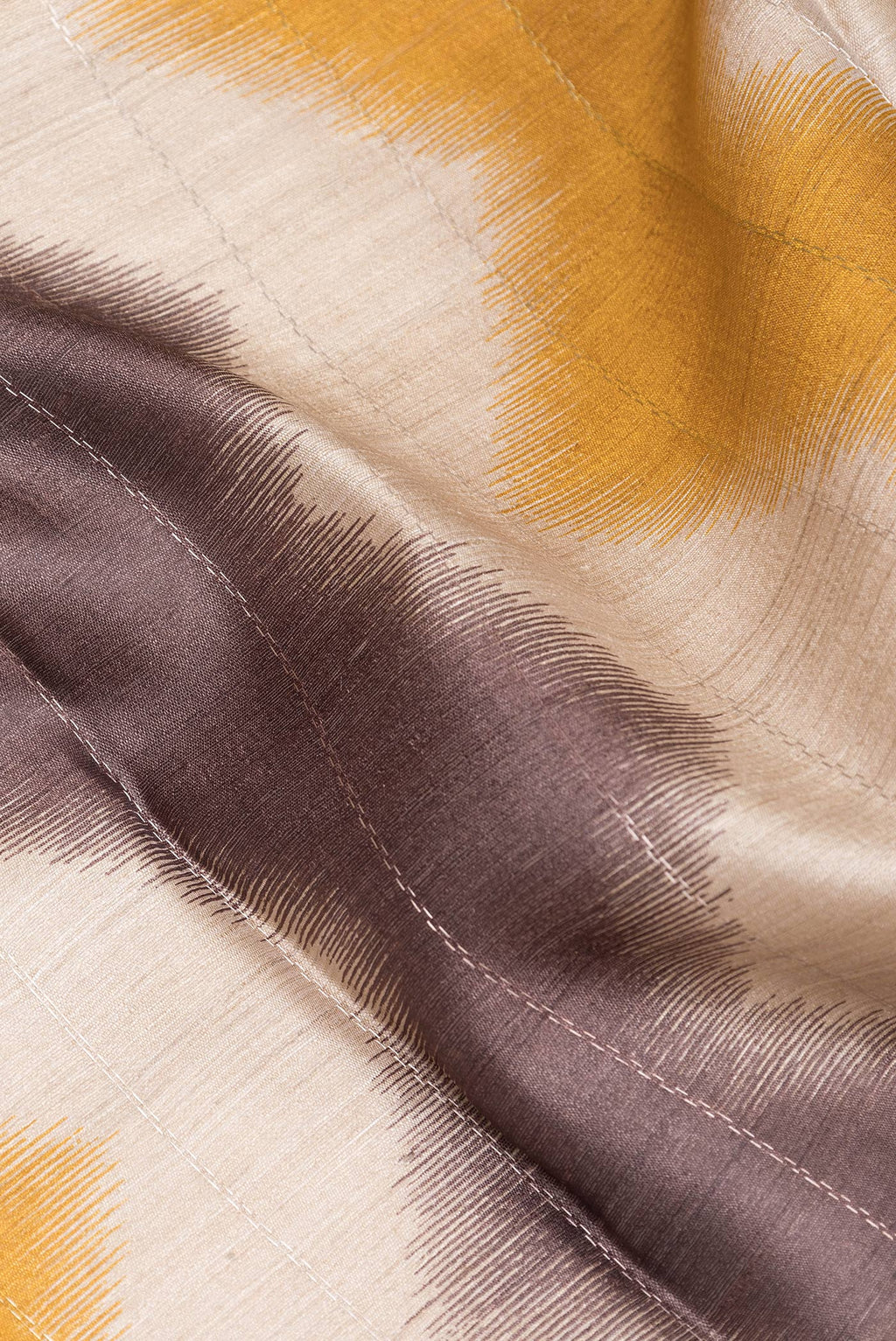 Close up of Multi Color Tussar Silk Saree with Printed design on the body and Zari Border.  displaying folds