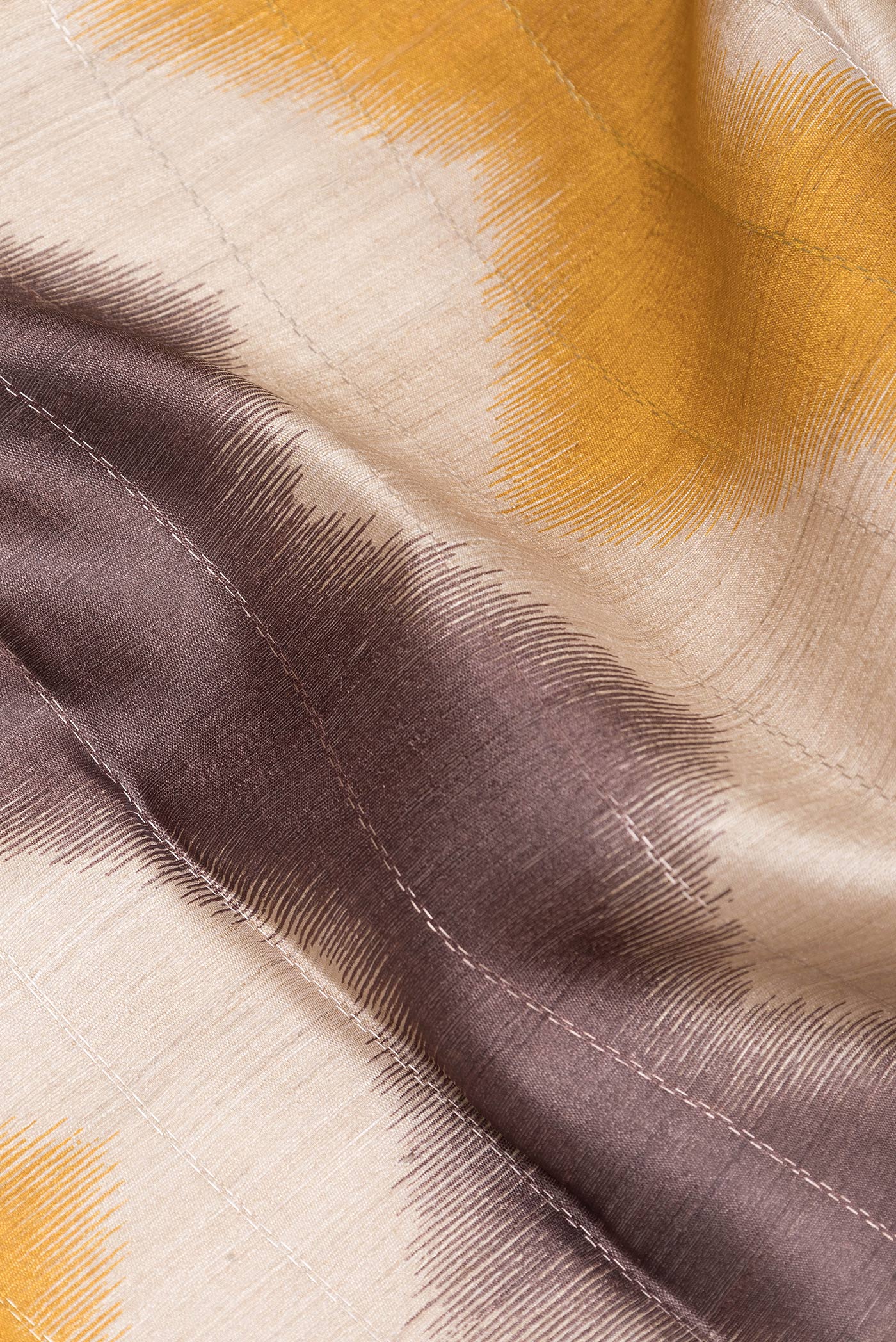 Close up of Multi Color Tussar Silk Saree with Printed design on the body and Zari Border.  displaying folds