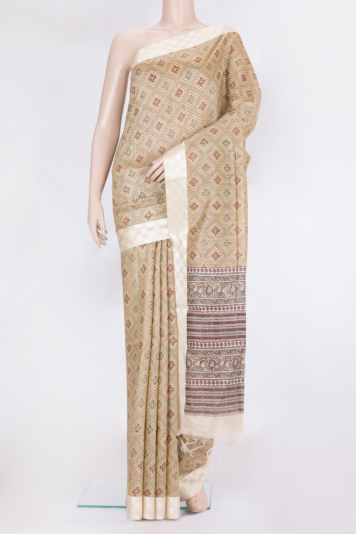 Sandal Tussar Silk Saree with Printed design on the body and Fancy Border.  displayed on a mannequin