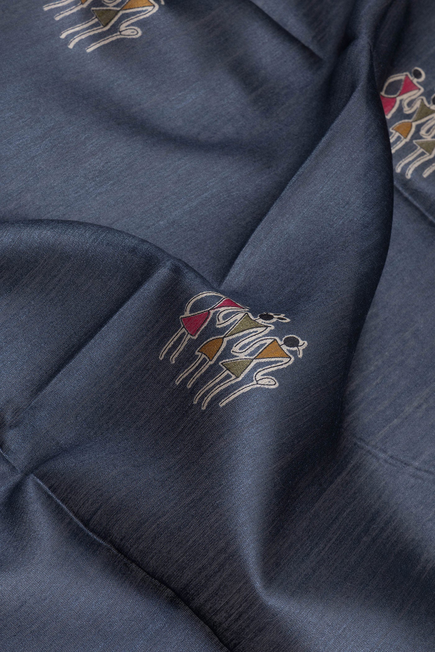 Close up of Grey Tussar Silk Saree with Printed design on the body and Printed Border.  displaying folds