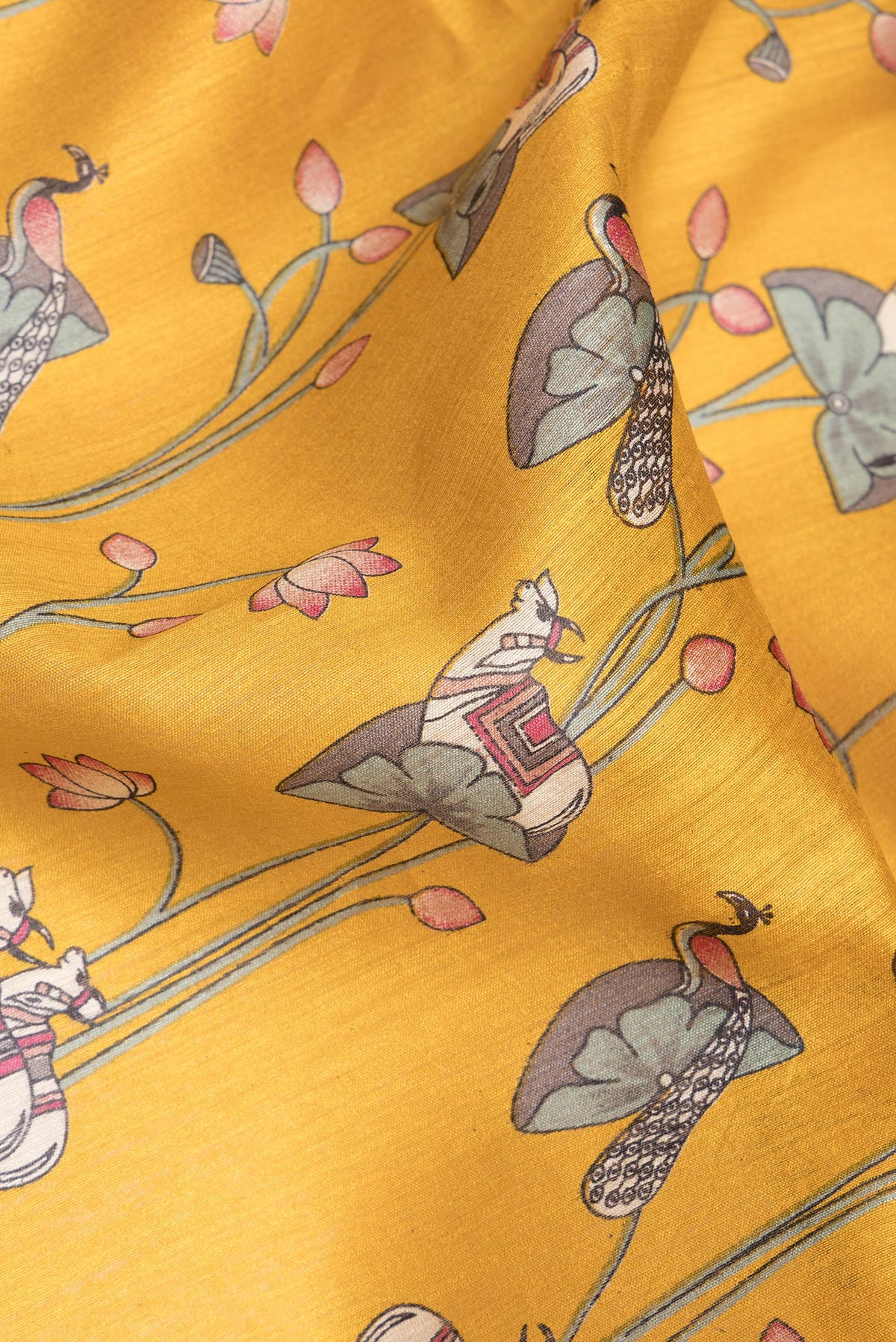Close up of Mustard Dual Tone Tussar Saree with Printed design on the body and Zari Border.  displaying folds