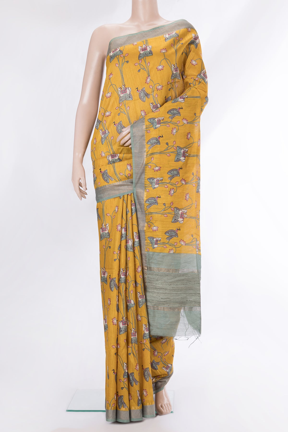 Mustard Dual Tone Tussar Saree with Printed design on the body and Zari Border.  displayed on a mannequin