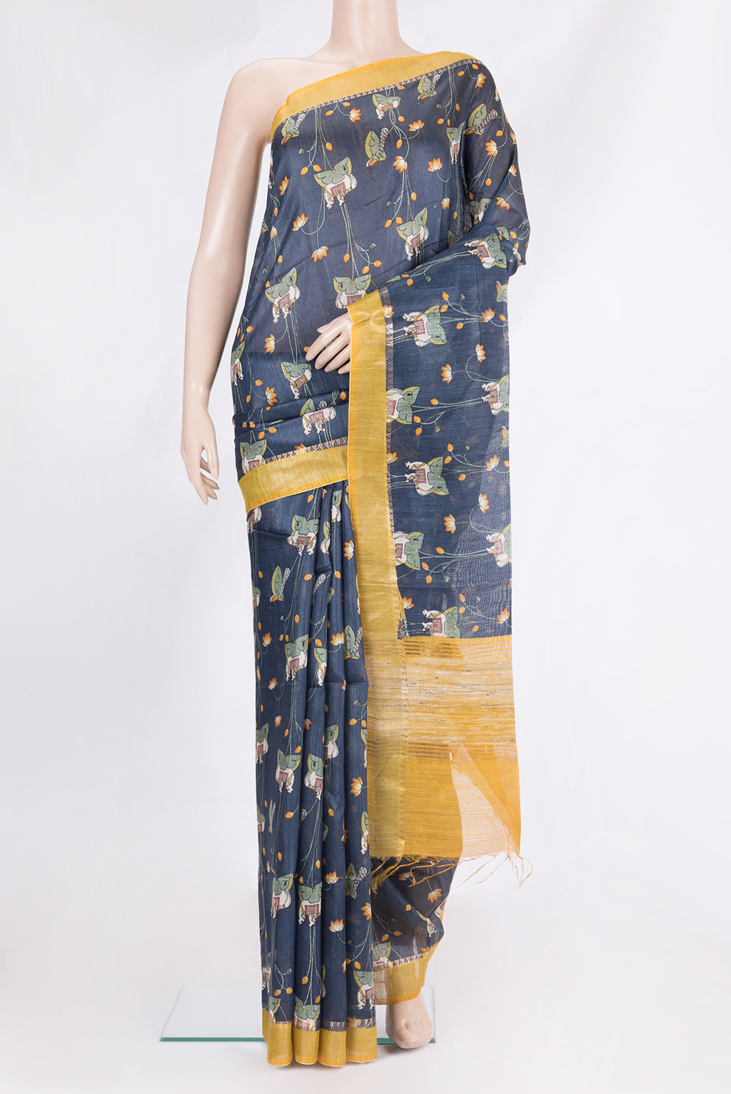 Navy Blue Tussar Saree with Printed design on the body and Zari Border.  displayed on a mannequin