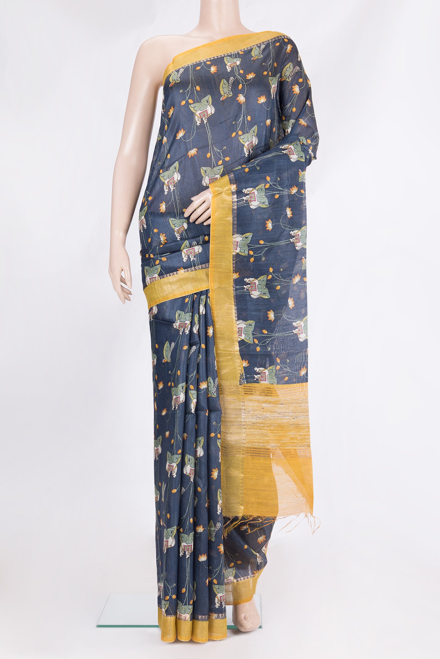Navy Blue Tussar Saree with Printed design on the body and Zari Border.  displayed on a mannequin