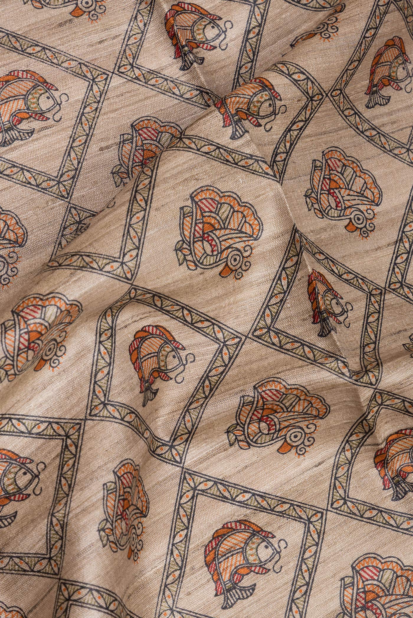 Close up of Beige Tussar Saree with Printed design on the body and Printed Border.  displaying folds