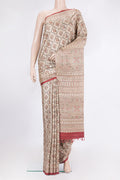 Beige Tussar Saree with Printed design on the body and Printed Border.  displayed on a mannequin
