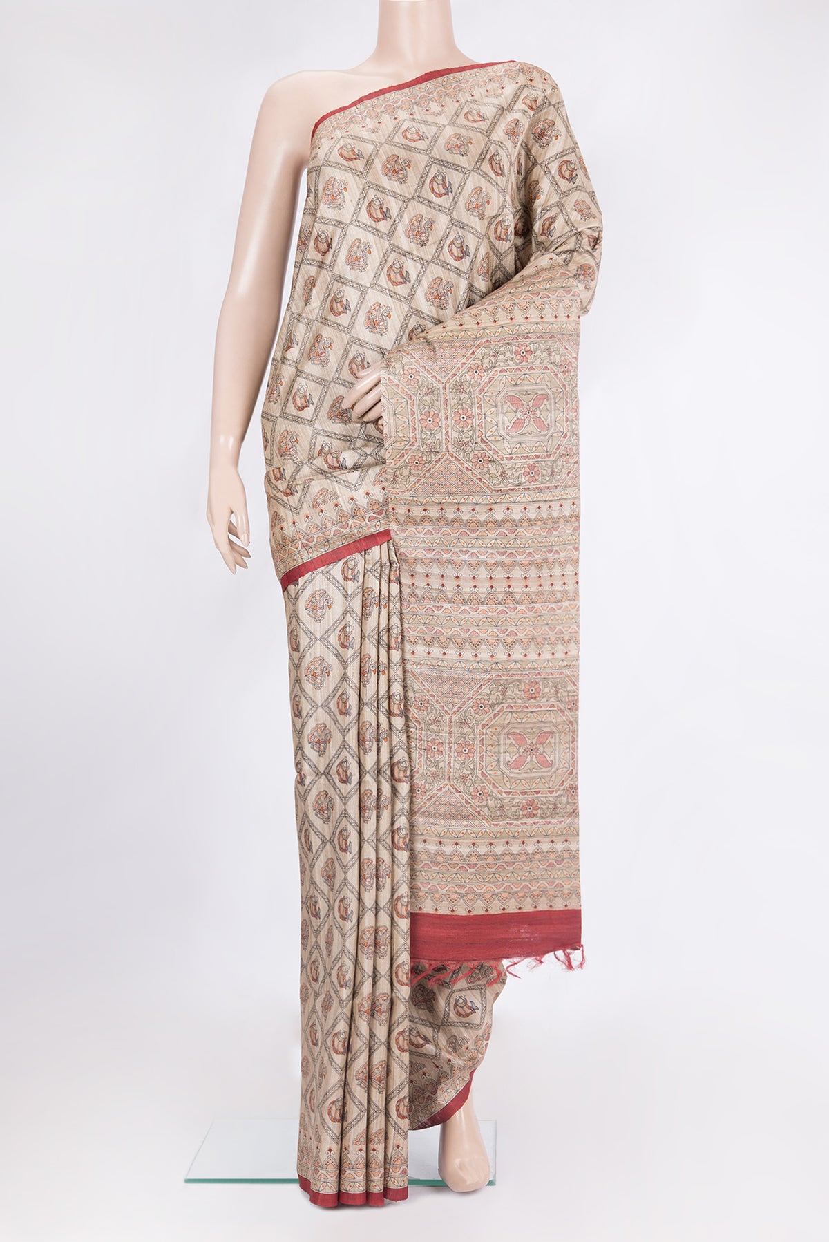 Beige Tussar Saree with Printed design on the body and Printed Border.  displayed on a mannequin