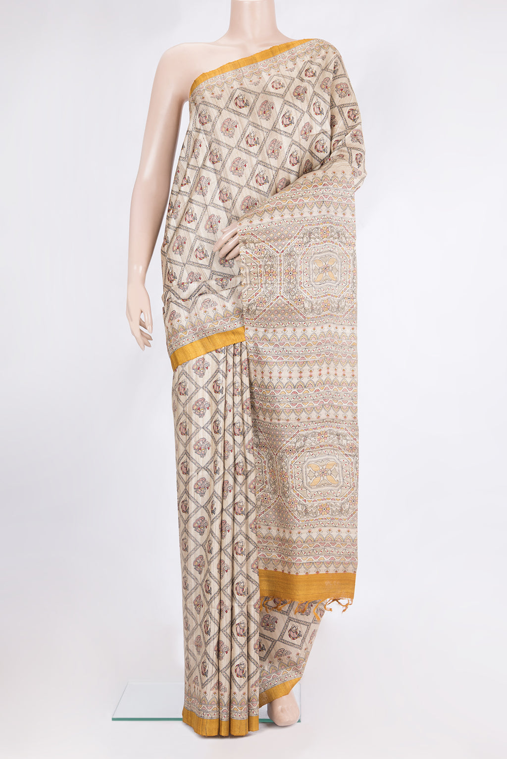 Beige Tussar Saree with Printed design on the body and Printed Border.  displayed on a mannequin