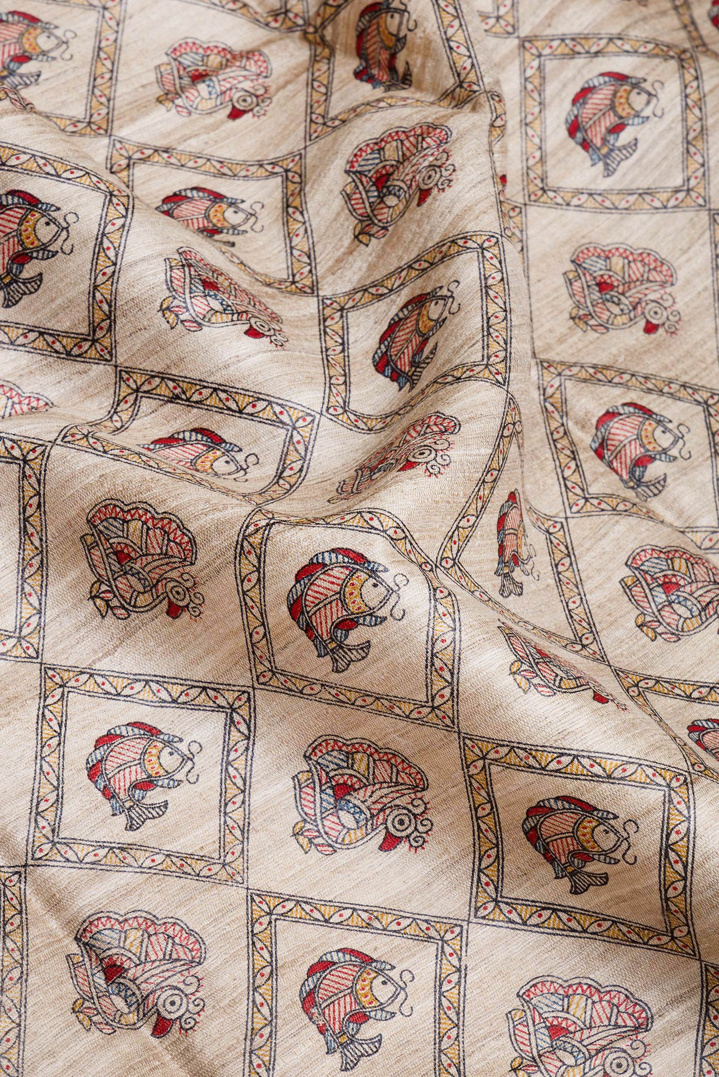 Close up of Beige Tussar Silk Saree with Printed design on the body and Fancy Border.  displaying folds