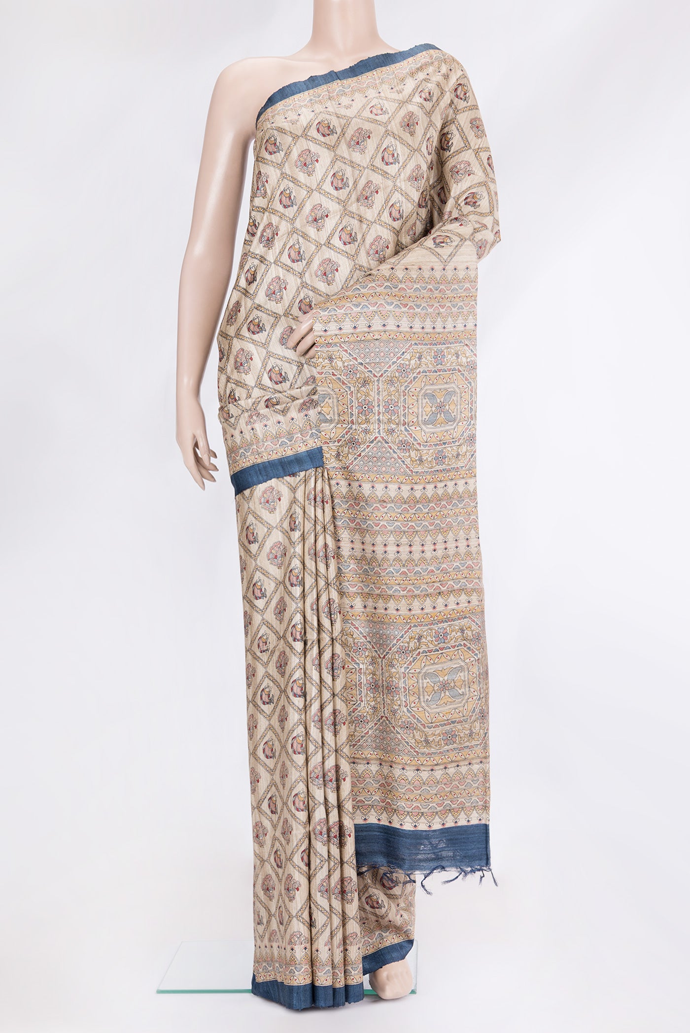Beige Tussar Silk Saree with Printed design on the body and Fancy Border.  displayed on a mannequin