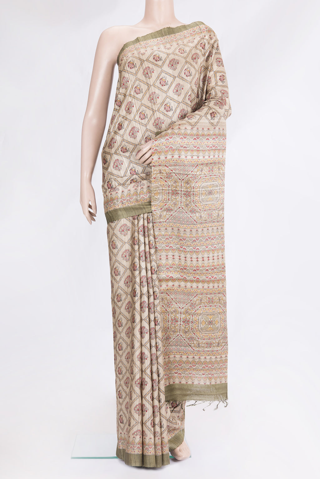 Beige Tussar Silk Saree with Printed design on the body and Fancy Border.  displayed on a mannequin