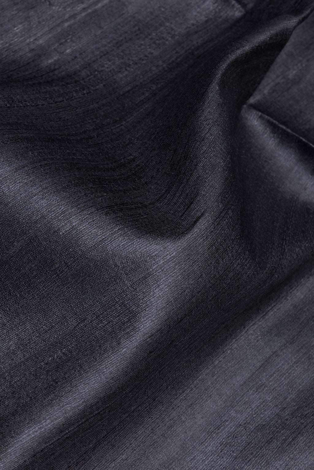 Close up of Grey Tussar Silk Saree with Plain Body and Fancy Border.  displaying folds