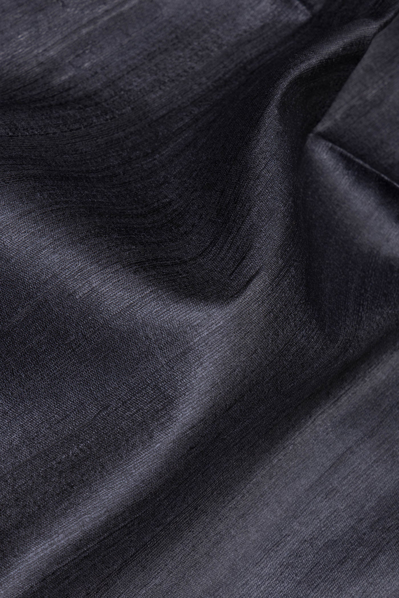 Close up of Grey Tussar Silk Saree with Plain Body and Fancy Border.  displaying folds