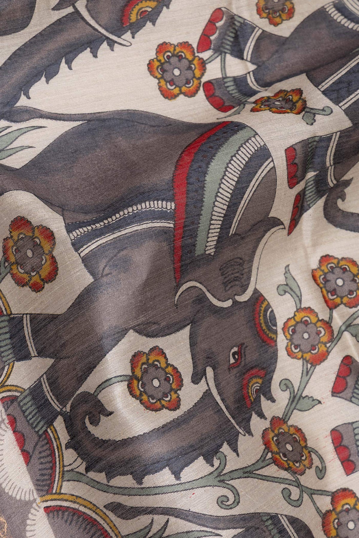Close up of Grey Tussar Saree with Printed design on the body and Zari Border.  displaying folds