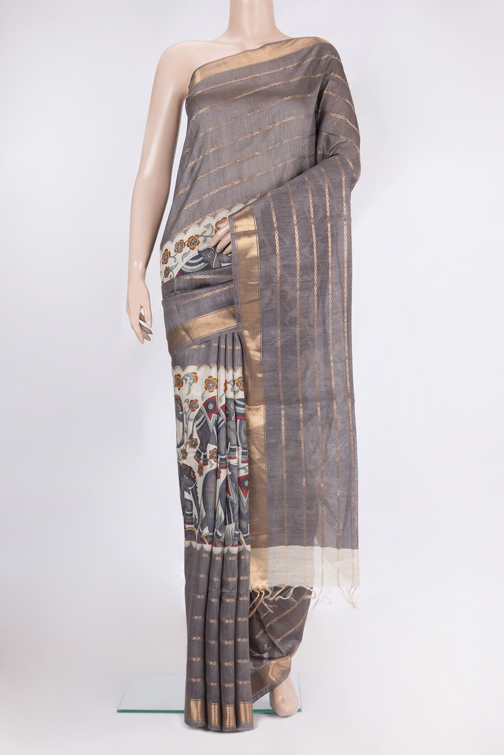 Grey Tussar Saree with Printed design on the body and Zari Border.  displayed on a mannequin