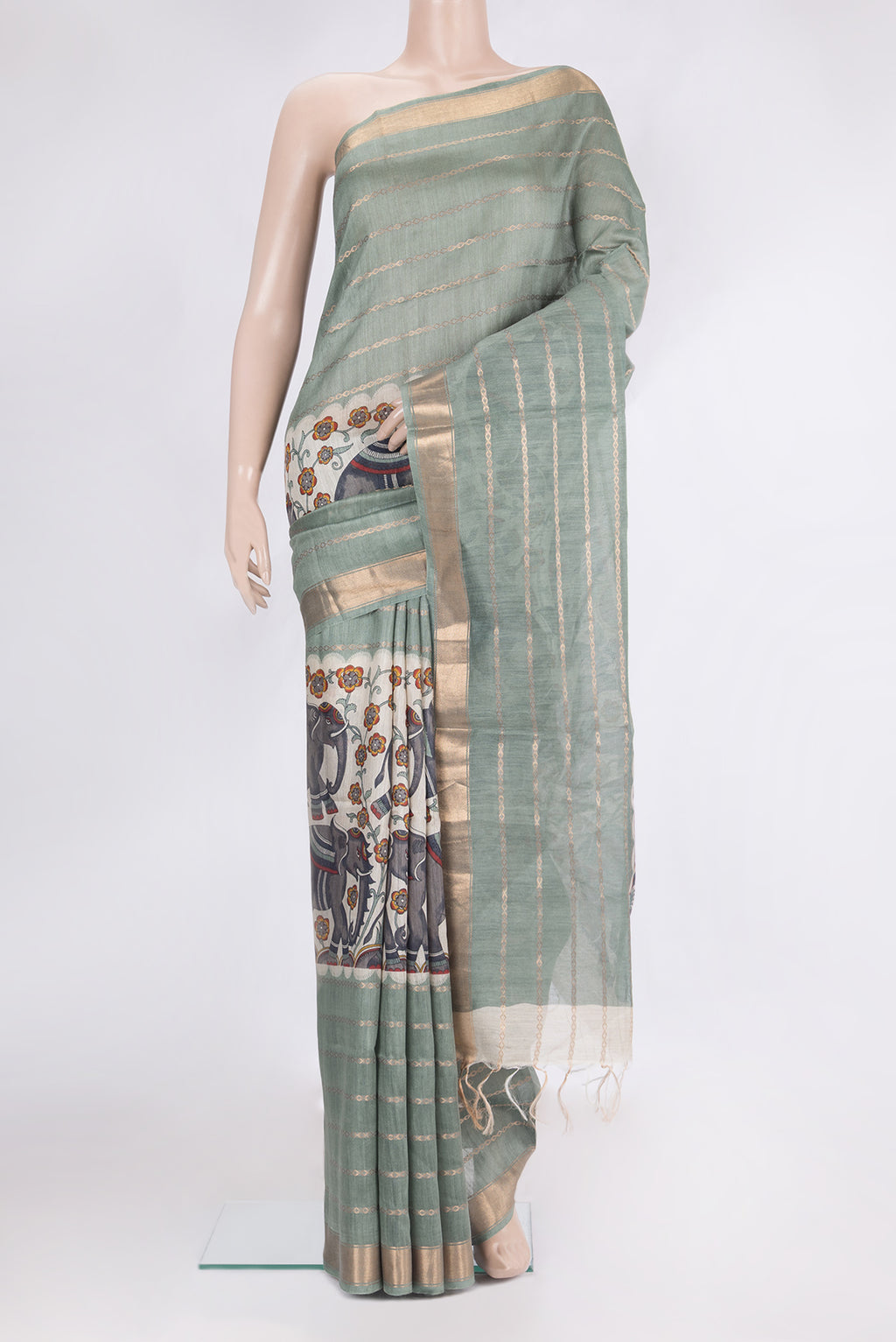 Beige Tussar Saree with Printed design on the body and Zari Border.  displayed on a mannequin