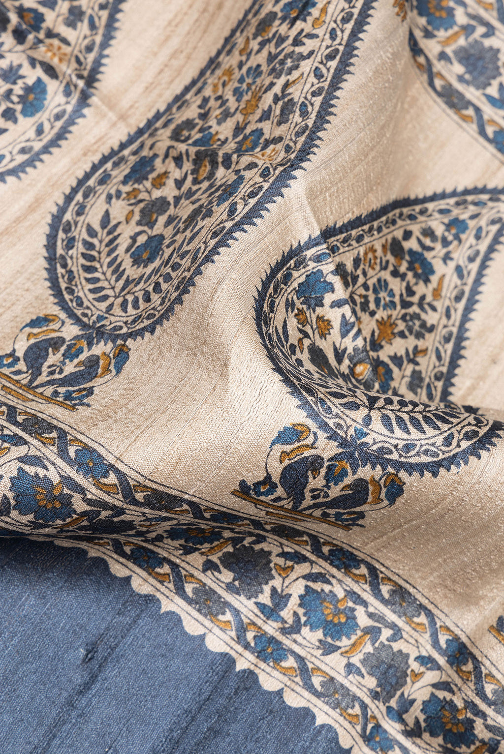 Close up of Grey Tussar Saree with Zari Butta on the body and Zari Border.  displaying folds