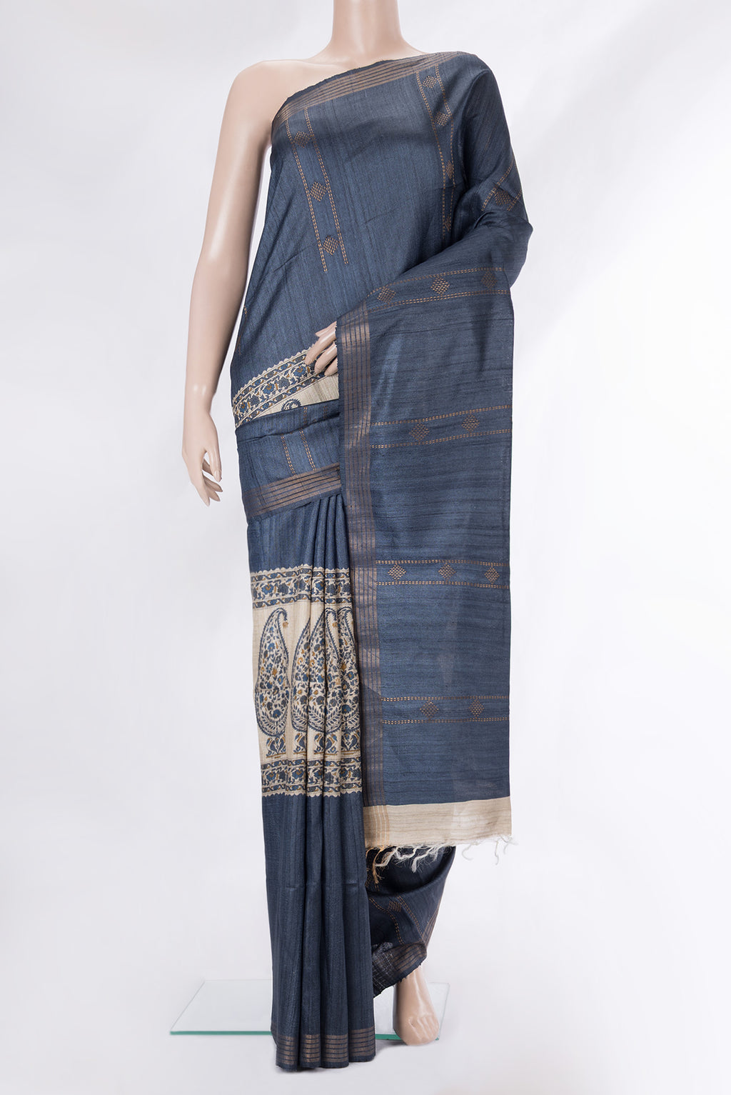 Grey Tussar Saree with Zari Butta on the body and Zari Border.  displayed on a mannequin