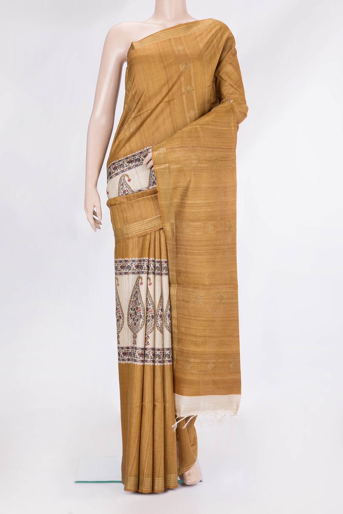 Mustard Tussar Silk Saree with Zari Butta on the body and Zari Border.  displayed on a mannequin