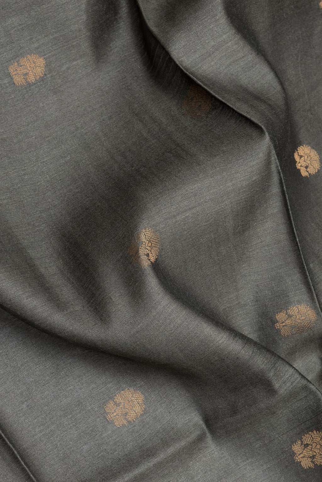 Close up of Grey Tussar Silk Saree with Zari Butta on the body and Fancy Border.  displaying folds