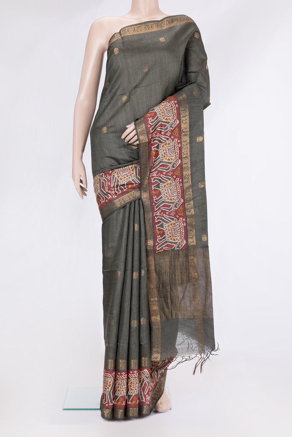 Grey Tussar Silk Saree with Zari Butta on the body and Fancy Border.  displayed on a mannequin