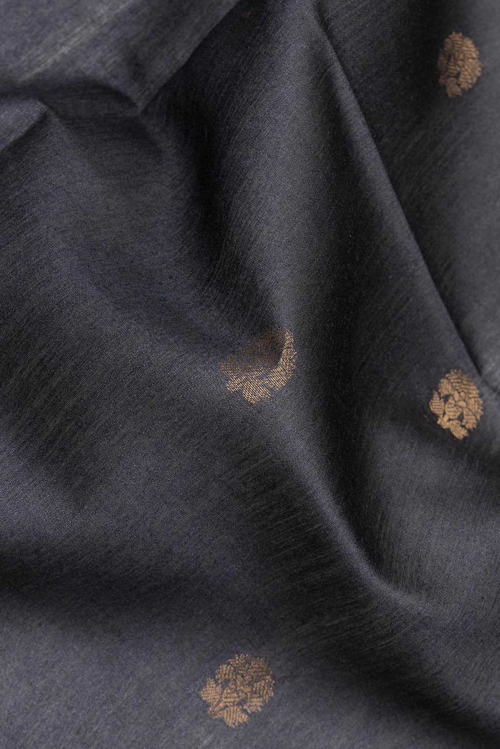 Close up of Black Tussar Saree with Zari Butta on the body and Fancy Border.  displaying folds